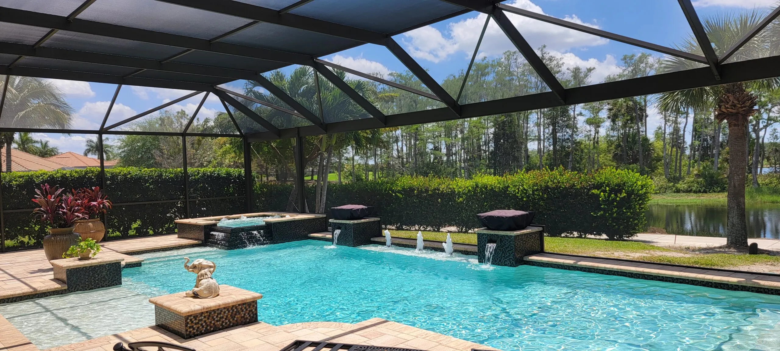 Screened pool enclosure over a pool and paver deck