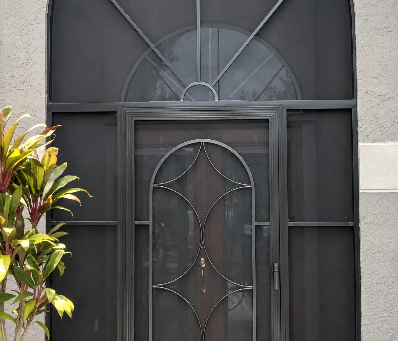 The same entry enclosed with black screen walls and a decorative aluminum door