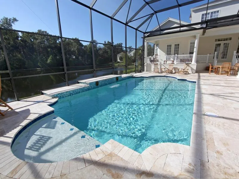 Finished custom swimming pool with screen enclosure