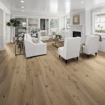 Wide-plank oak flooring installed in a bright living room with a fireplace