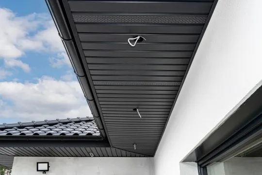 New white soffit and fascia installation along the roofline of a Florida home