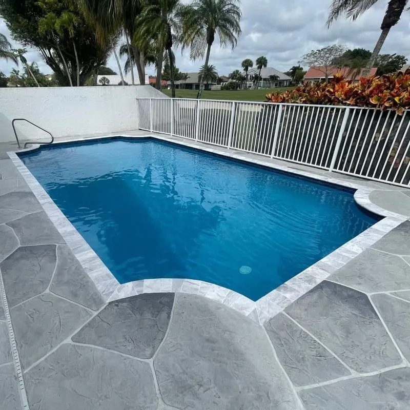 Restored swimming pool with new quartz finish and stamped concrete deck