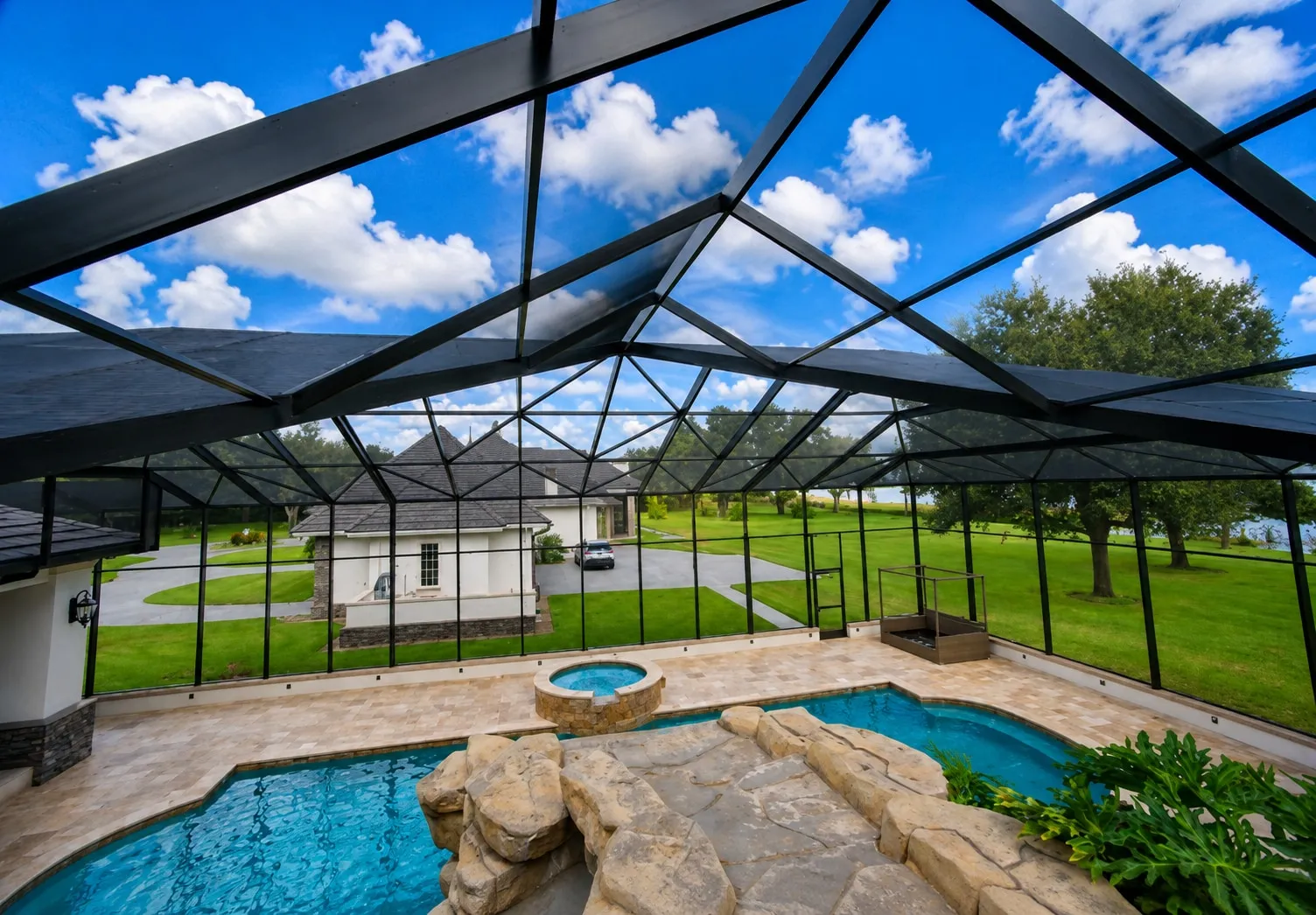 Two-story Florida home with rescreened lanai openings above a fenced backyard pool