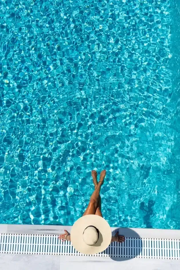 Woman in a sun hat relaxing poolside in Sarasota, Florida