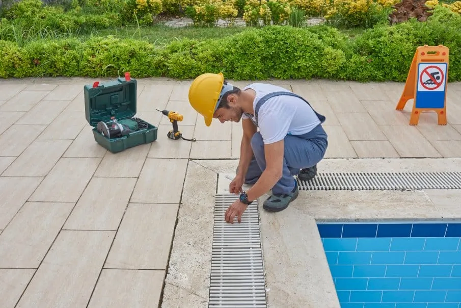 Technician resurfacing a pool deck in Florida