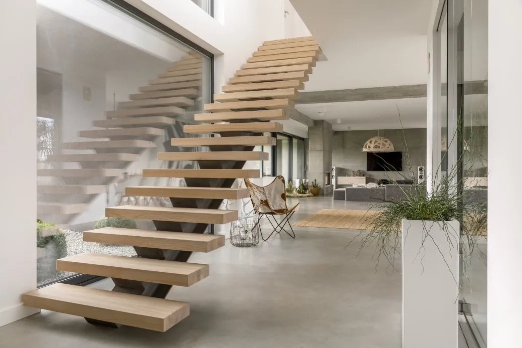 Floating oak stair treads on a central steel stringer in a modern interior