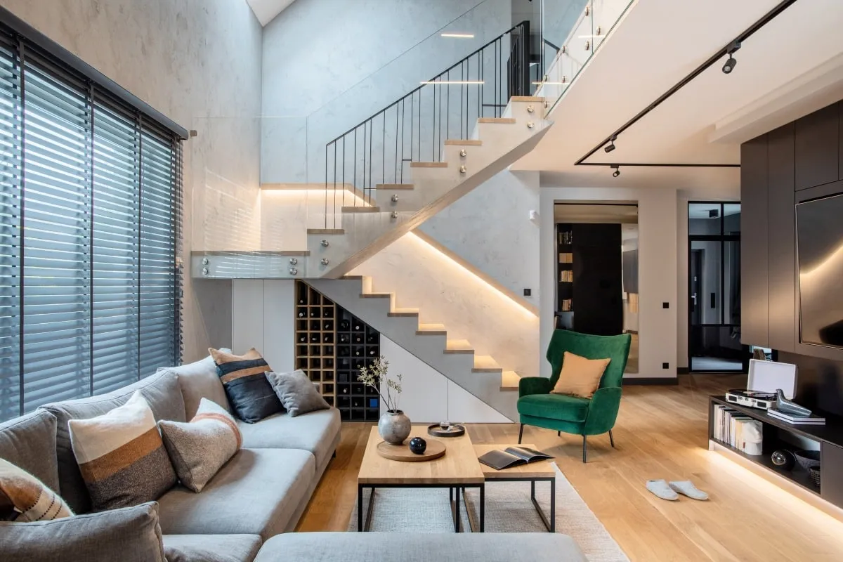 LED-lit staircase with metal balusters and under-stair wine storage