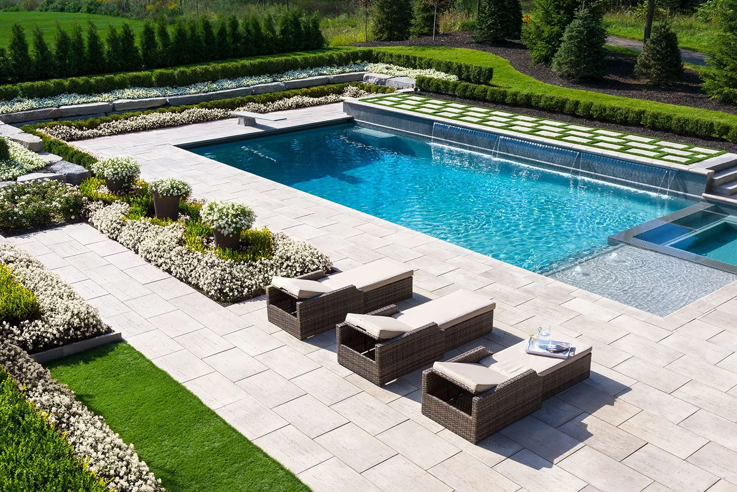 Travertine patio paver slabs around a pool