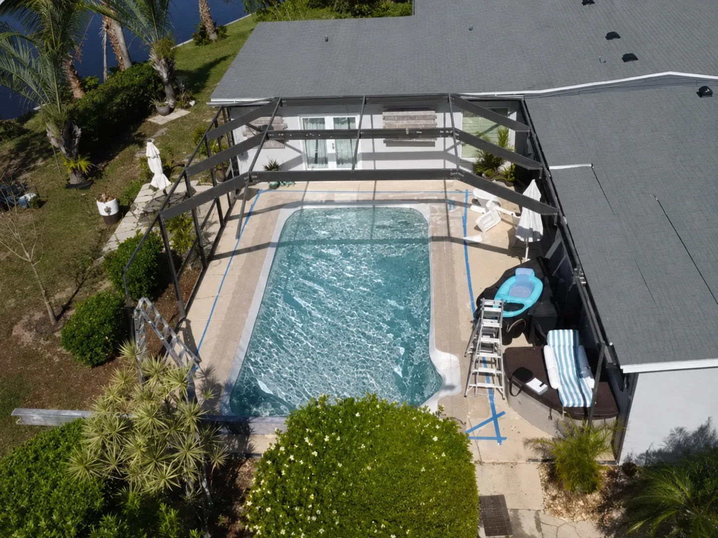Pool cage with rusted screws and multiple torn panels — before pool cage repair