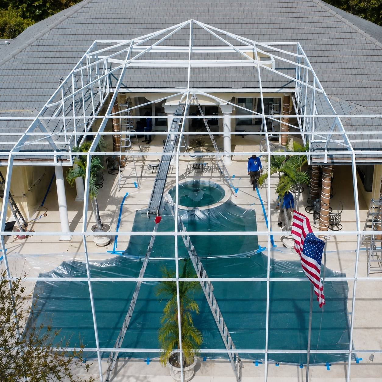 Two-story screen enclosure with restored frame and new screens spanning the back of a Sarasota home